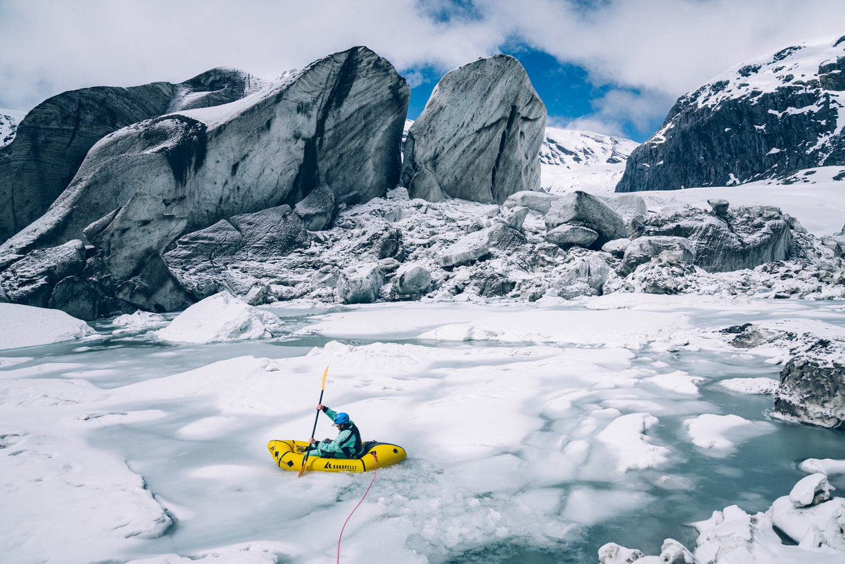 The Volta Glacier is melting quickly — to pass its terminus and continue downriver we had to cross a partially frozen melt lake. We decided pushing through the ice in our packrafts was the safest way. Photo Jasper Gibson