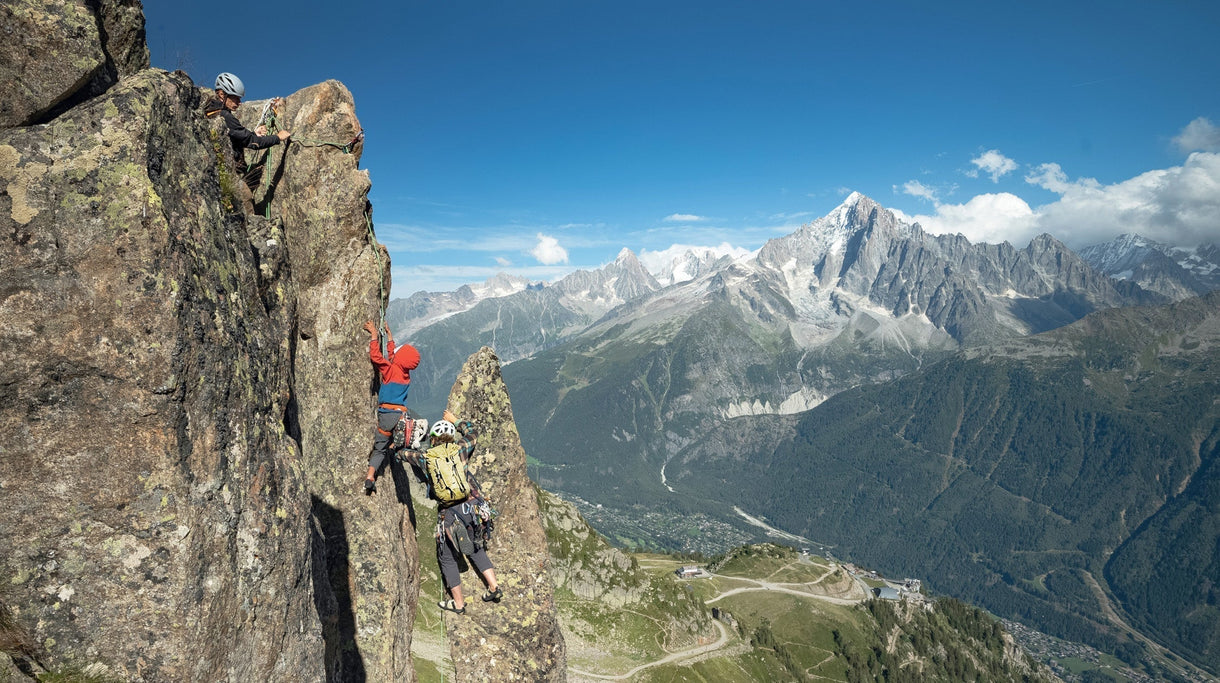 Zoe Hart gives Mika and Buni a boost while climbing Le Brévent, high above their home in Chamonix, France. Photo: Pierre Cadot