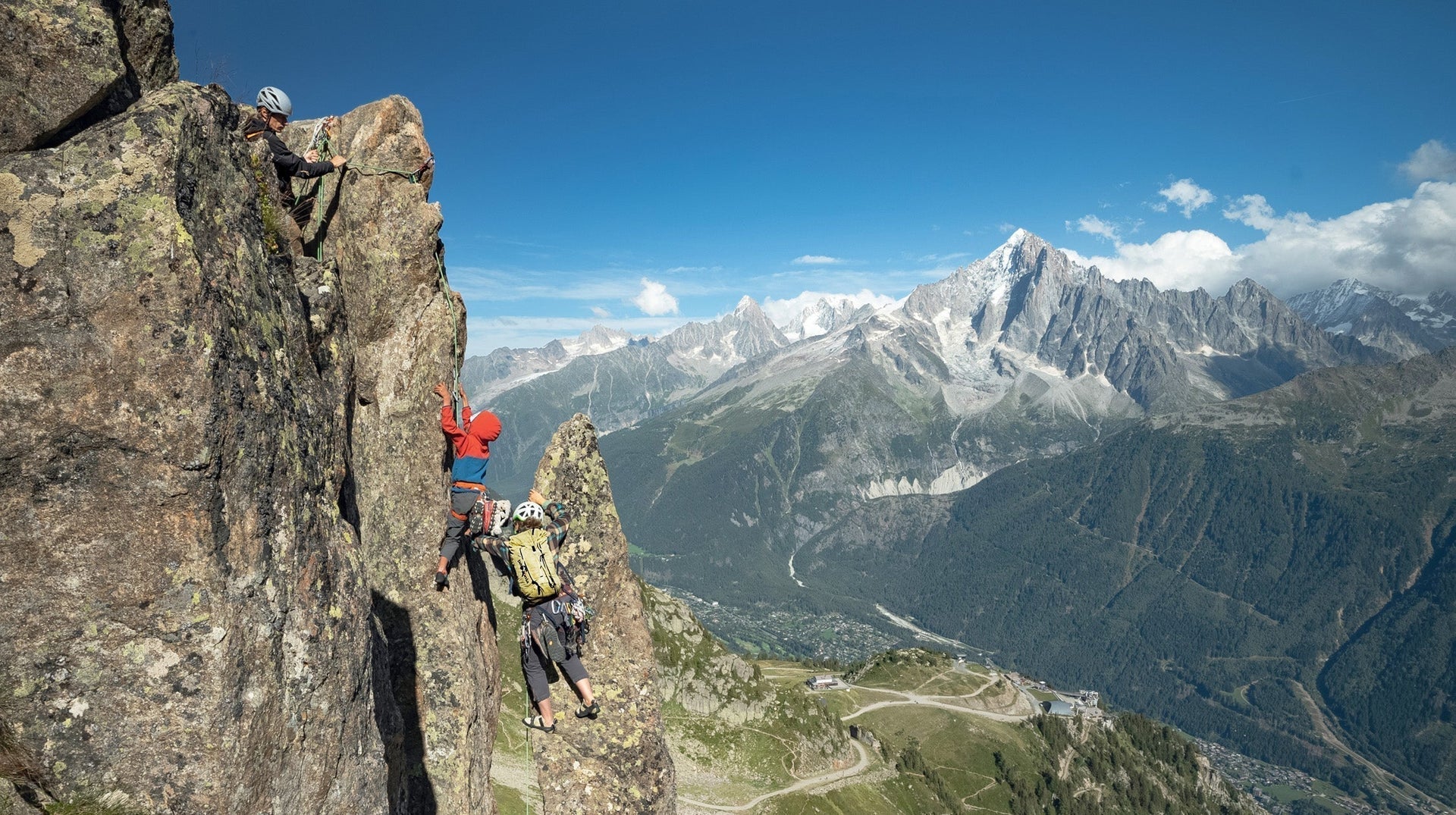 Zoe Hart gives Mika and Buni a boost while climbing Le Brévent, high above their home in Chamonix, France. Photo: Pierre Cadot