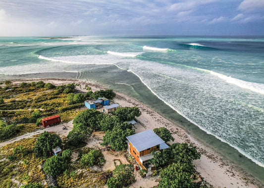Opening image: Arlene's Shangri-La — built with partner Jake and daughter MG — in foreground, booming north swell filling the frame. Photo Arlene Bax