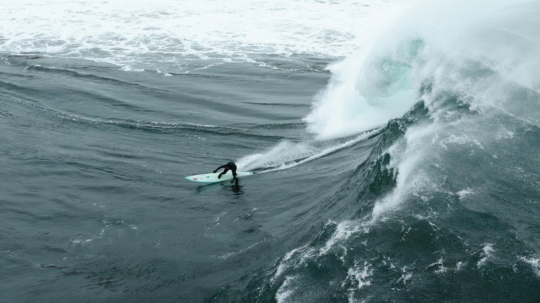 Person surfing on a wave in the ocean