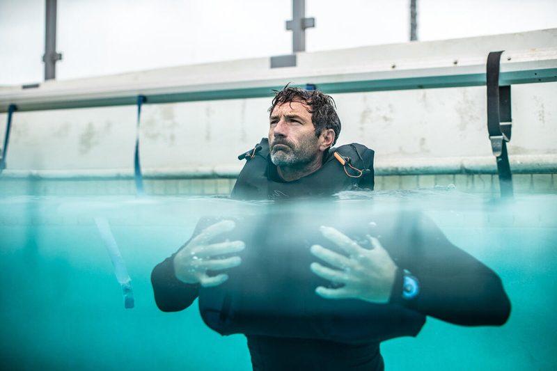 A tester in a pool wearing a PSI Vest.