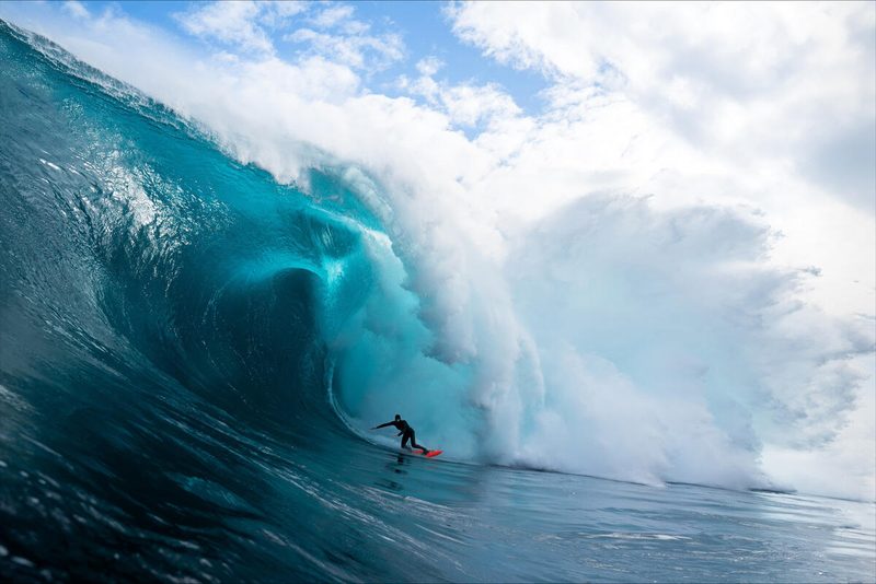 A surfer riding a large wave.